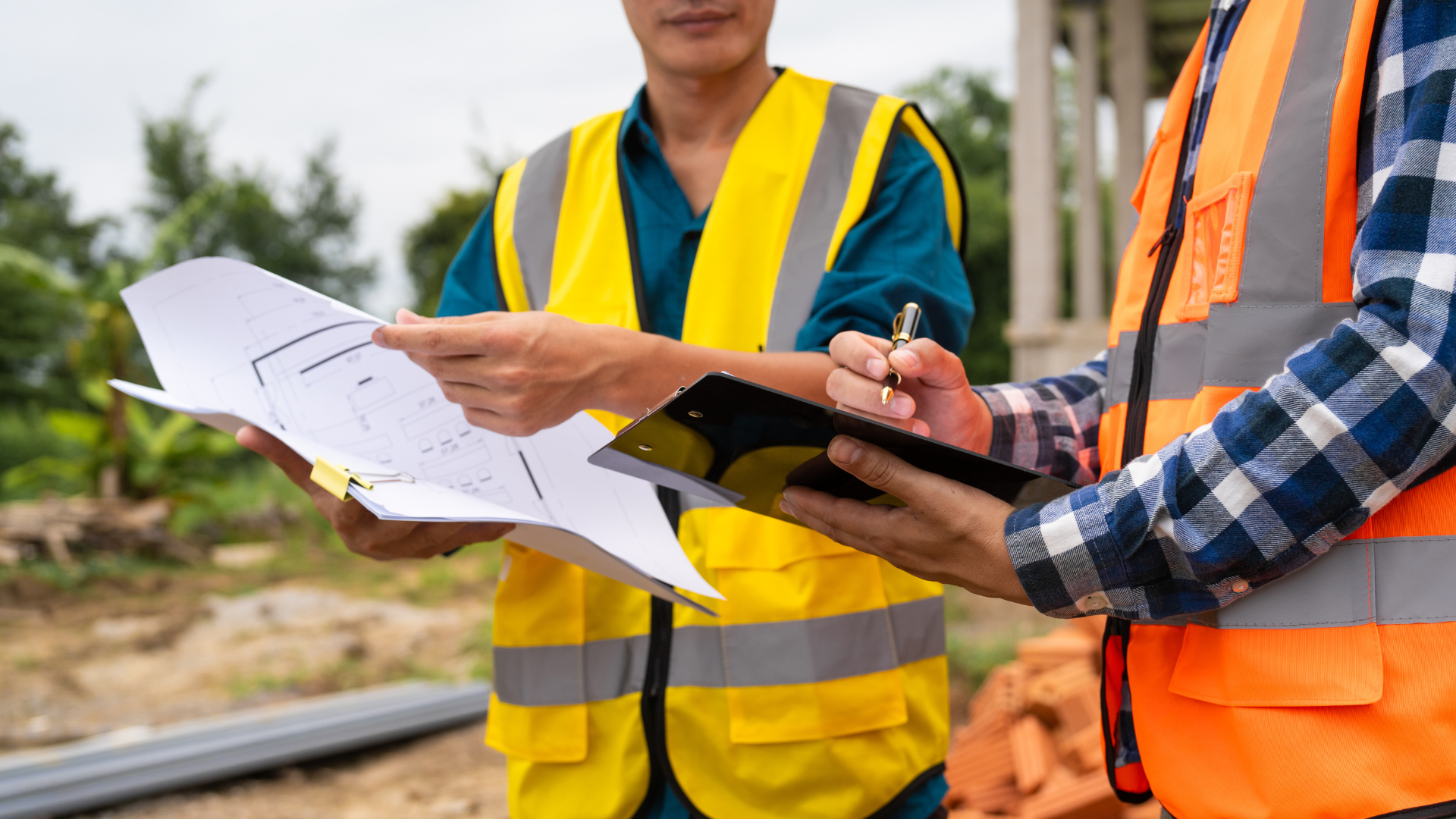 Roofing crew reviewing inspection plans and taking notes on a job site